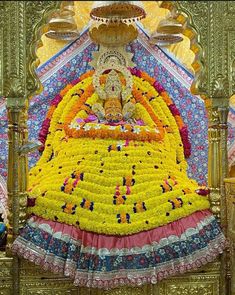 the statue is covered in flowers and decorations