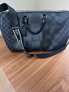 Limited Edition Louis Vuitton Keepall 50 Bandouliere Duffle Graphite Damier. Will include original black strap that is brand new never used and also strap shown in picture which was an add on and cost $600 by itself.