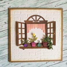 an open window with potted plants in it on a wooden table next to a white brick wall