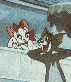 two cartoon cats sitting next to each other