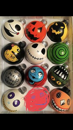 six halloween ornaments in a box with faces painted on the balls and eyes drawn on each ornament