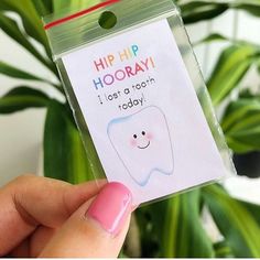 someone holding up a card with a tooth on it that says hip hooray i lost a tooth today