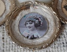 three silver frames with an image of a woman on them