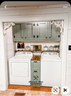 a white washer and dryer sitting inside of a laundry room next to cabinets