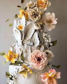 a large white cake with flowers on top