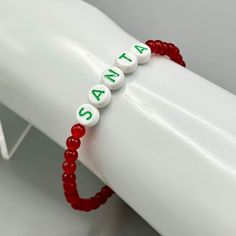 Gemstone Santa beaded stretch bracelet Genuine Jade approximately 7 inches Present is glass strung on professional latex free elastic. We do our best to choose each stone carefully and purposeful for every piece.. However there might be slight differences in color size shape and clarity which makes each item unique and one of a kind.Each piece of jewelry will come in a colored satin drawstring bag for it’s protection and storage or to be ready to give as a gift.Our gemstone jewelry are all origi Flexible Hypoallergenic Beaded Bracelets For Gifts, Gift Beaded Stretch Bracelet With Round Beads, Gift Beaded Stretch Bracelet, Beaded Stretch Bracelet Gift, Adjustable Beaded Stretch Bracelet For Christmas, Beaded Stretch Bracelet As Gift, Flexible Beaded Stretch Bracelet Gift, Adjustable Stretch Bracelet With Round Letter Beads, Gift Stretch Bracelet With Round Letter Beads