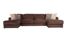 a brown sectional couch with pillows on it's back and the seat facing outward