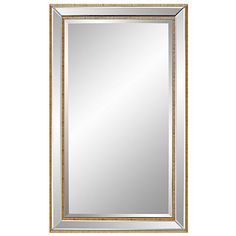 a gold framed mirror on a white wall