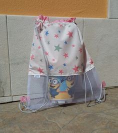 a bag that is sitting on the ground next to a wall with stars around it