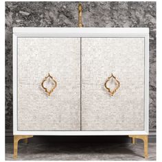 a white and gold cabinet with two doors on the front, one door open to reveal a