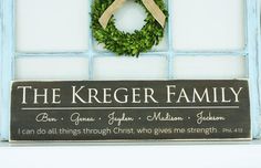 the kreger family sign is hanging on a window sill next to a wreath