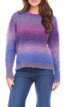 a woman wearing a purple and blue sweater