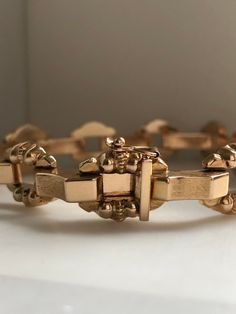 This is a beautiful vintage 18K Rose Gold Bracelet. It is a nice heavy weight. The center links are a satin finish and the rounded, decorative links are high polish. The length is 8 inches. The clasp is a slide with a safety lock on the side. Stamped 750 (18K) weight:19.21 grams Vintage, excellent condition 1970s original. With any pre-owned/Vintage/Antique items, it is common to have some wear, As we inspect each piece of our jewelry, we make sure the wear and tear is acceptable within industry Antique Rose Gold Bracelets For Formal Occasions, Vintage Formal Bracelet With Box Clasp, Vintage Yellow Gold Bracelet With Clasp, Vintage Yellow Gold Jewelry With Clasp, Vintage Rose Gold Bracelet For Anniversary, Vintage Yellow Gold Bracelet With Box Clasp, Vintage Gold Jubilee Bracelet, Vintage Gold Bracelet With Box Clasp, Vintage Gold Bracelet With Bracelet Strap As A Gift