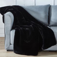 a couch with a black blanket on top of it