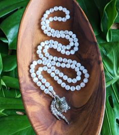 "☾ This mala necklace is created with natural, ethically-sourced Gemstones:  SELENITE  Clearing, Cleansing, Inner Peace, Calmness of Mind, Release of the Old, and New Beginnings ✸ Natural Selenite (Grade AA) 8mm beads ✸ Vintage rhodium plated brass Buddhist Prosperity Turtle Amulet, Made in Thailand, Blessed in Bhutan ✸ Sterling Silver & Vintage Rhodium plated brass beaded details This mala features 108 beads, hand-knotted in traditional style between each bead. The beads are each 8mm in diamete White Hand-strung Crystal Necklace For Gift, Spiritual Beaded Pearl White Necklace, Spiritual Pearl White Beaded Necklace, White Amulet Jewelry For Meditation, Spiritual Moonstone Beaded Necklace With Natural Stones, Healing White Gemstone Beaded Necklaces, Spiritual Moonstone Crystal Necklace With Gemstone Beads, White Spiritual Necklace With Polished Beads, White Gemstone Beaded Necklaces For Meditation