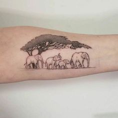 an elephant family under a tree tattoo on the arm