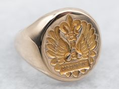 "The engraving on this signet ring is backwards, as it was likely used for wax seals! The words \"SUB ALIS STO\" are engraved, meaning \"We Stand Under Our Wings\".  Please note that this signet ring has its original monogram, unfortunately, this piece cannot be altered without affecting the quality of the piece, please feel free to contact us to help you find your perfect signet ring in your style and budget!  Metal: 14K Yellow Gold Top Measurements: 11 x 14 mm, Oval Ring Size: 3 Marks: \"BBB 14K\" Stamped on the inside band To view a video of this piece check out the link below: https://vimeo.com/832402566 SKU #: A24653 Each piece has been identified and graded by a Graduate Gemologist who has been certified by the Gemological Institute of America (GIA). We have six brick-and-mortar stor Classic Polished Signet Ring For Commemoration, Classic Engraved Signet Ring For Commemoration, Classic Ceremonial Signet Ring With Polished Finish, Luxury Engraved Signet Ring For Commemoration, Luxury Engraved Ring With Polished Finish For Commemoration, Luxury Engraved Ring For Commemoration With Polished Finish, Classic Signet Ring With Engraving For Commemoration, Classic Engraved Signet Ring For Ceremonial Use, Classic Hallmarked Signet Ring For Commemoration