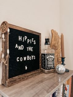 a wooden sign that says hippies and the cowboy's sitting on top of a shelf