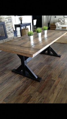 a wooden table sitting on top of a hard wood floor