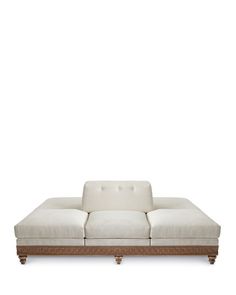 a white couch sitting on top of a wooden frame