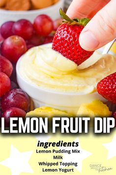 a hand dipping a strawberry into a bowl of lemon fruit dip