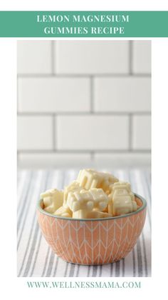 a bowl filled with sliced up lemons on top of a table next to a white brick