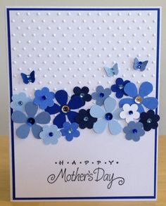 a mother's day card with blue flowers and butterflies