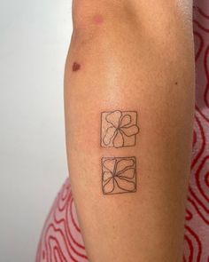 a woman with a tattoo on her arm that has three squares and flowers in them