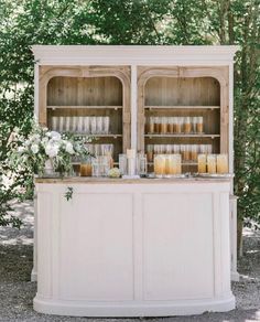 an outdoor bar with candles and flowers on it