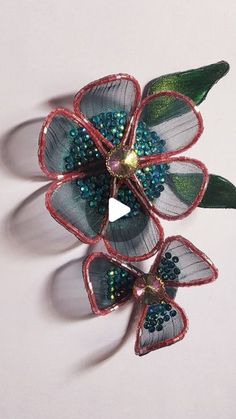 three flower brooches sitting on top of each other