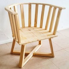 a wooden chair sitting on top of a tile floor