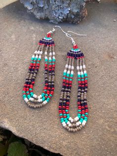 michelle clan longhair Lightweight everyday earrings. Bright red, green turquoise, white, navy blue, and gray beaded earrings. all earrings are handmade and unique. i use beads that were given to me by my grandmother, recycled, bought locally, or from small businesses. please note, there will be some imperfections. my earrings are a modern take on traditional design and cherokee clan style. w o l f: traditional. strong. ornate. b i r d: simple. petite. feminine. l o n g h a i r: bohemian. dramat Beaded Earrings Native Beadwork Inspire Uplift ⭐, Free Seed Bead Patterns Tutorials, Beaded Sunglasses Native Americans, Sarape Pattern, Native Blanket, Handwoven Earrings, Beaded Earrings Tutorials, Beaded Earrings Diy, Beaded Earrings Patterns