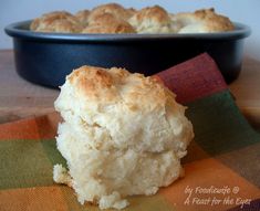 a close up of a biscuit in a pan on a table next to a napkin