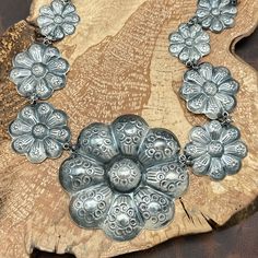 This Is A Gorgeous Sterling Silver Statement Necklace By The World-Famous Mixtec Artist Federico Jimenez. The Necklace Features A Graduated Design Of Scalloped Flowers, Ranging In Diameter From Just Over 1” To Just Over 3”. Each Flower Has Decorative Stampings On Every Petal As Well As The Center. The Flowers Are Joined By Rings Accented With Tiny 5-Petal Flowers, Adding To The Intricate Design. A Decorative Hook And Eye Closure Completes The Elegant Look. The Necklace Is Stamped With Federico’s Hallmark And Sterling At The Center Back Of The Centerpiece, As Well As The Third And Fourth Flowers On The Left And The Second And Fourth Flowers On The Right. The Total Length Around The Neck Silver Statement Necklace, Floral Statement Necklace, Silver Necklace Statement, Decorative Hooks, Intricate Design, The Flowers, Small Flowers, Womens Jewelry Necklace, Necklace Etsy