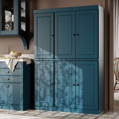 a kitchen with blue cupboards and white counter tops in the middle of the room