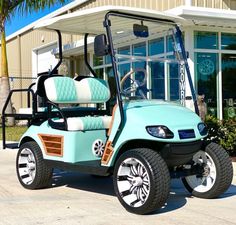 a light blue golf cart parked in front of a building