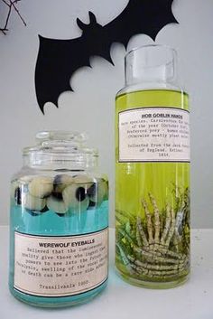 a bottle of witch eyeballs next to a glass jar filled with black and white balls