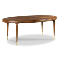 an oval wooden table with gold legs