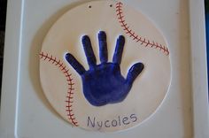 a baseball with a hand painted on it and the name nygoles written in blue