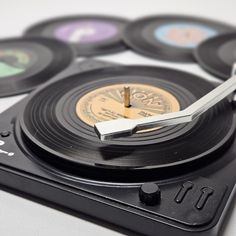 an old record player with four different colored discs on it's side and one has a metal blade in the middle