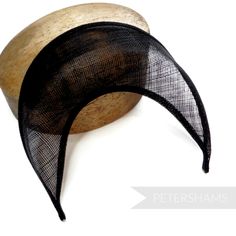 The shape of this season (and next's) has arrived! Halo crowns have stormed the millinery world and are the perfect step up from a chunky headband for a special occasion. Made from a double layer of high-quality stiffened black sinamay, this shape has a domed front with a hollow underside, sinamay bias finished edges and tapered ends that sit nicely at the side of the head. You will need to fit a headband to this shape to make it functional, and our 5mm satin covered headbands do the job just pe Adjustable Black Costume Hat With Round Crown, Adjustable Black Mini Hat With Round Crown, Black Adjustable Mini Hat With Round Crown, Black Adjustable Fascinator With Structured Crown, Black Structured Crown Headpiece For Summer, Adjustable Black Costume Hat With Pinched Crown, Black Costume Hat With Pinched Crown And Adjustable Fit, Black Adjustable Mini Hats With Pinched Crown, Black Costume Hat With Adjustable Structured Crown