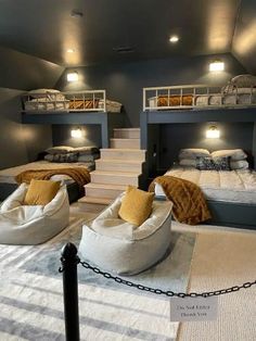 bunk beds are in the middle of a room that has stairs leading up to them