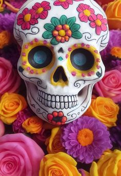 a colorful skull surrounded by flowers and roses