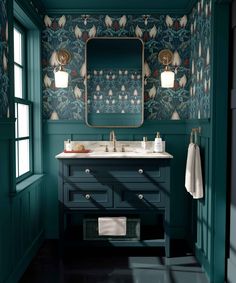 a bathroom with green walls and blue cabinets