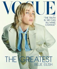 a woman in a white suit and tie on the cover of a magazine with her hands behind her back