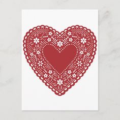 a red doily heart card on a white background with the word love written in it