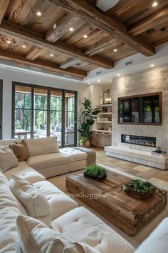 a living room with white couches and wooden beams on the ceiling, along with a flat screen tv