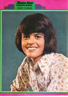 an old photo of a young person with long hair and wearing a flowered shirt