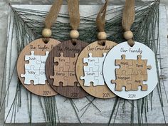 three wooden puzzle pieces with the names of each family on them hanging from twine