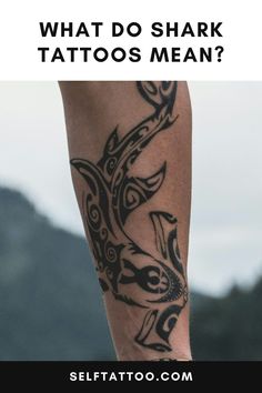 a man's leg with tattoos on it and the words what do shark tattoos mean?